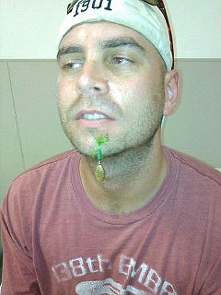0609121406.jpg - Midway through the trip, Dave cast a Rooster Tail right into his face.  He burrowed two of the three hooks into his flesh up past the barb forcing a delay in fishing to make a quick trip to the Emergency Room at the Front Royal Hospital.