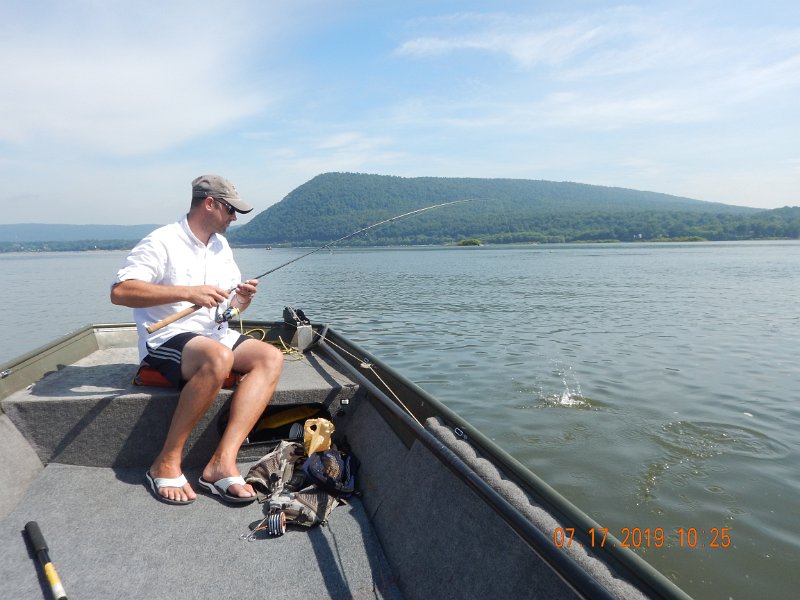 DSCN4425.JPG - Gary on the other hand was having shit for luck until this bass hit.  I took this pic just in case the fish didn't makeit into the boat.