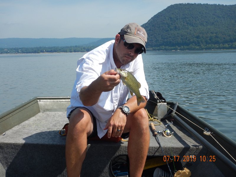 DSCN4427.JPG - Hey, where's the usual fish face....hummmm.  Anyway, he didn't get skunked, AND, shortly after this pic was taken,I stuck him in the back with a treble hook.  Kinda ruined the rest of our day.